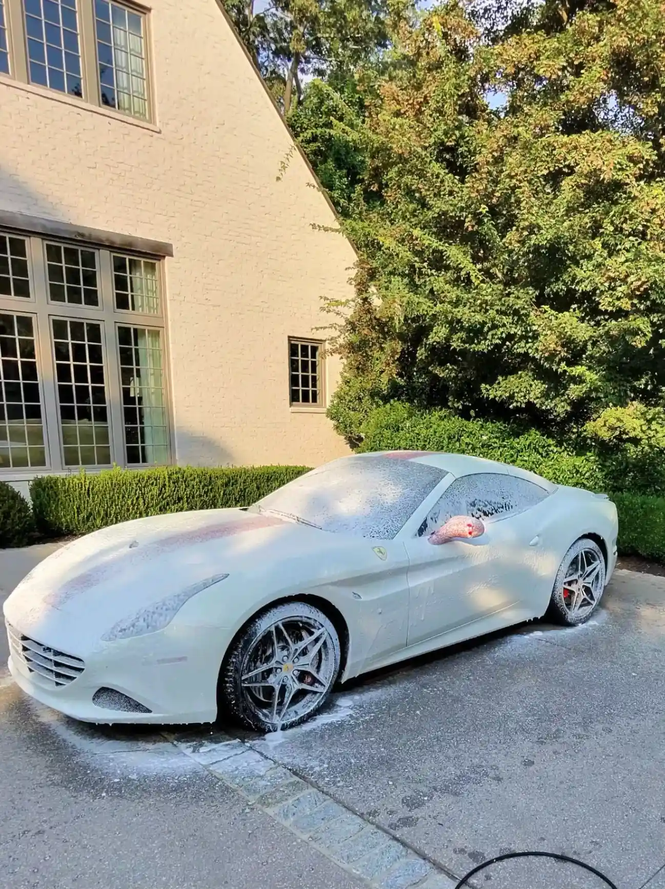 Ferrari being hand foam washed at a North Atlanta estate by 833 Auto Spa